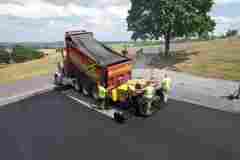 Construction workers laying asphalt on a driveway in Frederick, MD