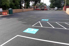 Freshly sealcoated commercial parking lot with ADA parking spaces in Frederick, MD